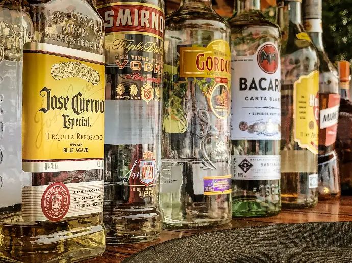 clear glass bottles on gray concrete floor